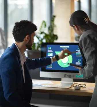 a man and woman looking at a computer screen